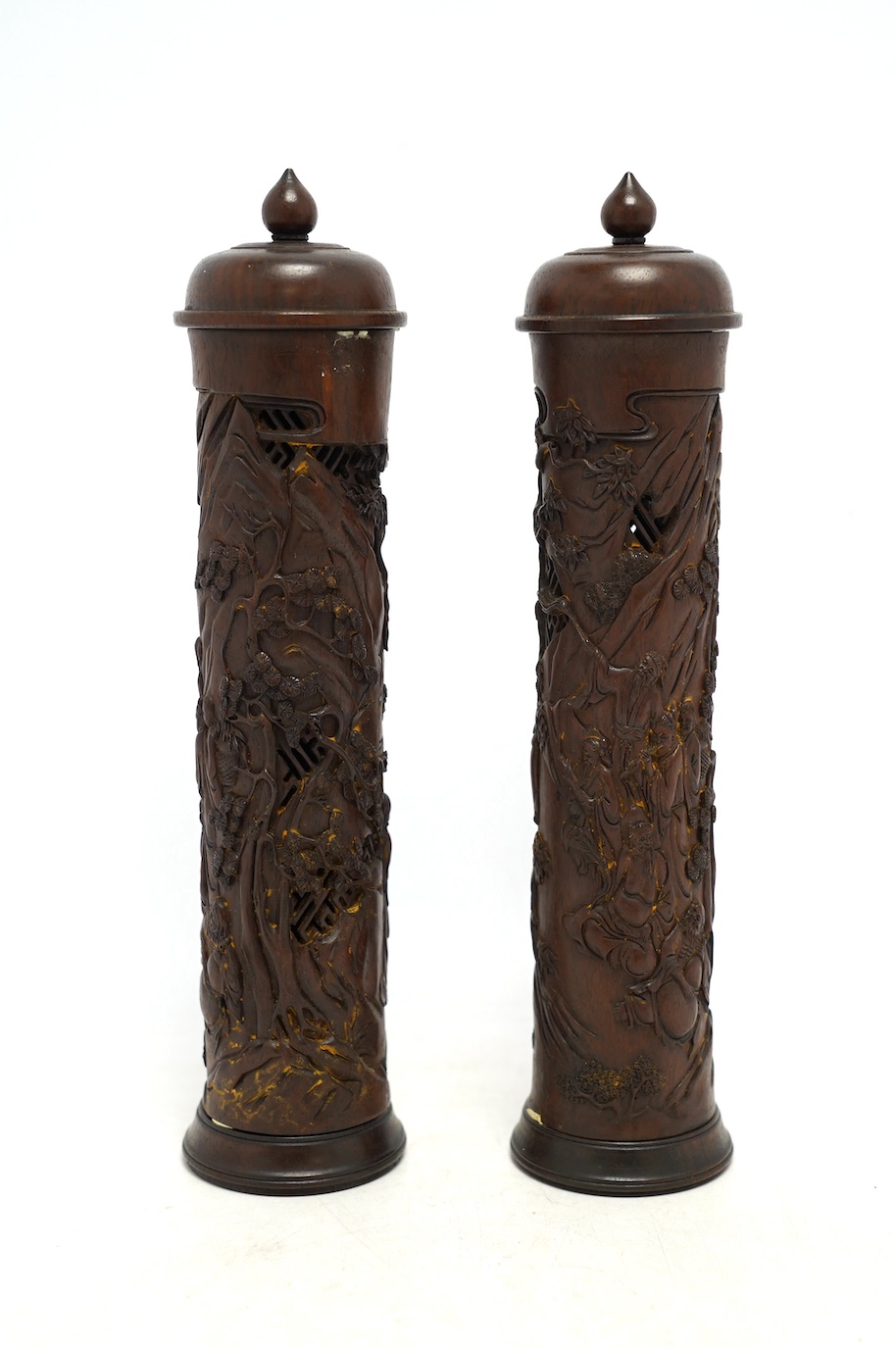 A pair of Chinese hardwood incense holders carved with trees and figures, cased, 29cm high. Condition - good